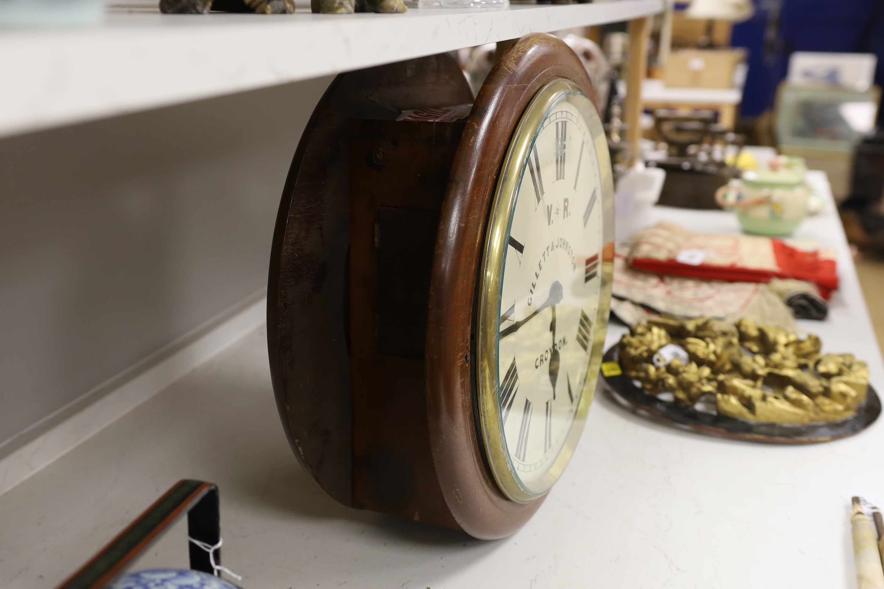 A Victorian double sided mahogany station / shop fusee timepiece, retailers name Gillett & Johnston, Croydon, 46cm diameter